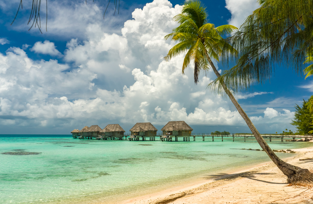 Overwater bungalows in a beach in Tikehau, Tahiti. Taken from the beach with bungalows in the background.