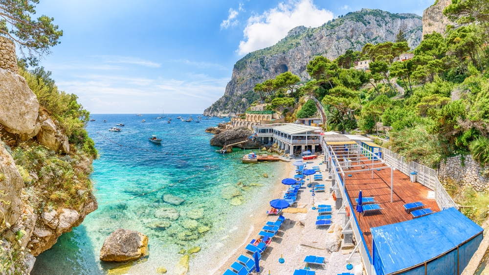 a beach club on island of capri overlooking waters and the rocks