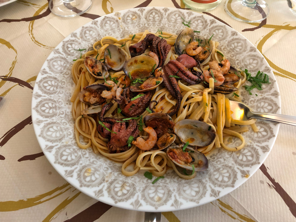 a seafood pasta dish with octopus, shrimp, claims and mussels