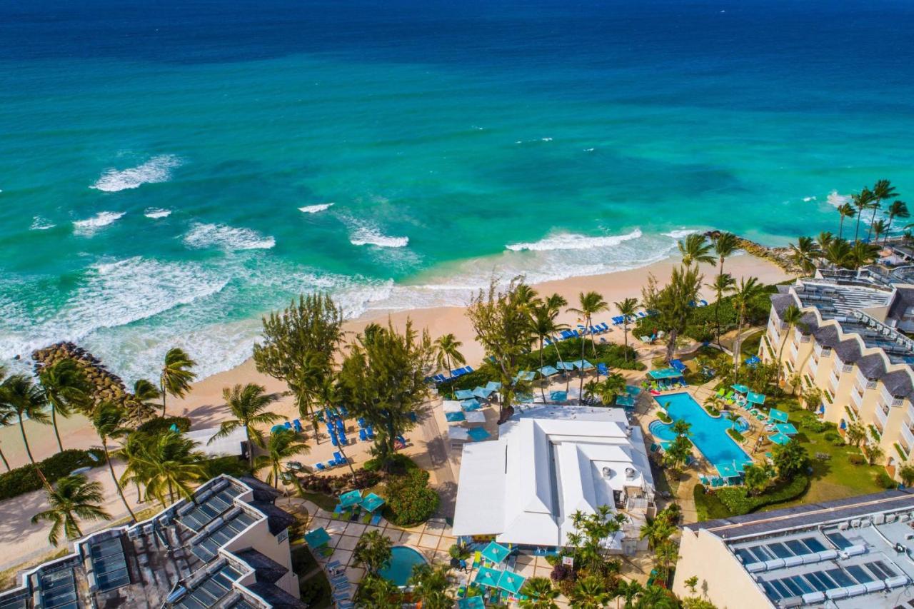 Aerial shot of Turtle Beach by Elegant Hotels with views of the ocean, the resort, the pool and all the landscaping. 