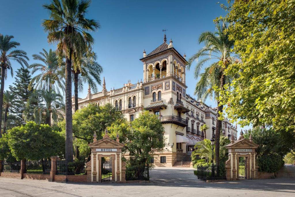 Outside of the Hotel Alfonso XIII in Seville. It's a colonial Spanish building with turrets and elaborately decorated. 