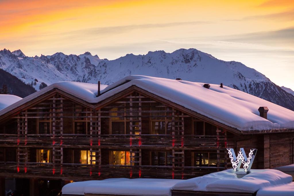 Wooden cabin like hotel covered in snow. 