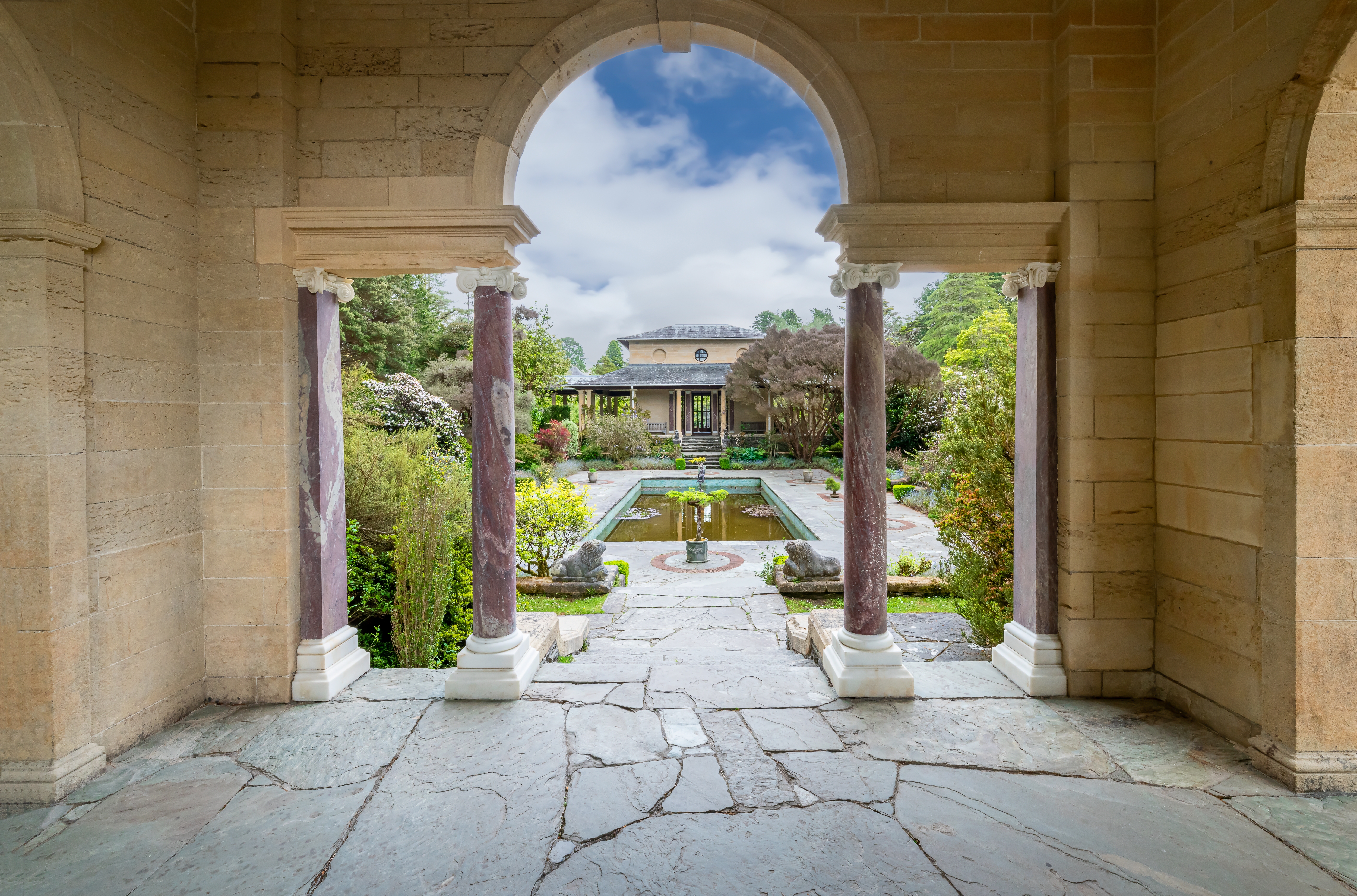 Looking out from one of the Roman Temple structures into the lush tropical gardens and reflecting pool beyond at Garnish Island