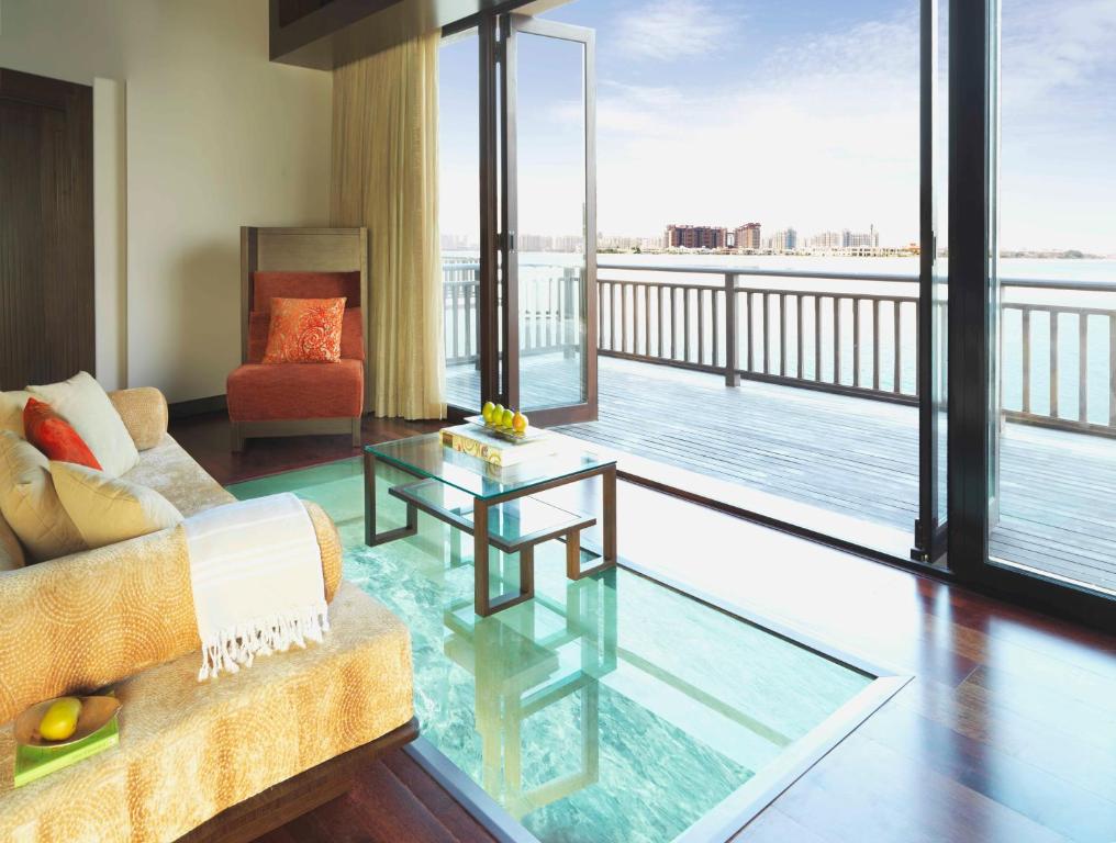 View from the sofa onto the ocean with a table on a glass floor.