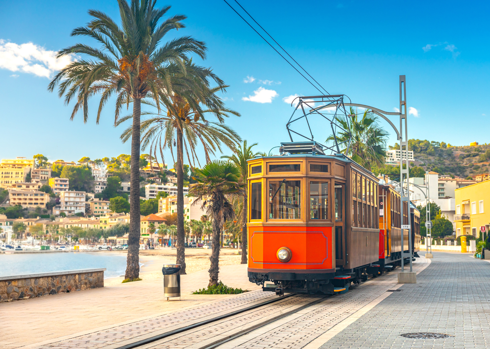 Of all mistakes to avoid in Spain, make sure to know transportation details: this orange trolley tears through the beach town!