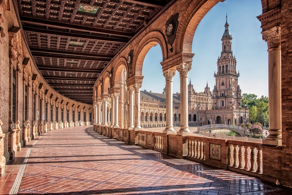 The walkway of a castle is stunning with it's classic architecture and curving sidewalk that leads toward a main hub, which you want to see, which is one of the mistakes to avoid in Spain.