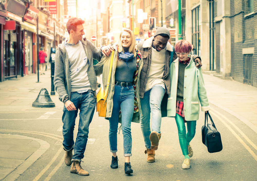 Four friends walking in one of the London areas.