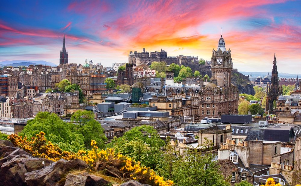 Edinburgh castle, Scotland at sunset. The article is about Scotland mistakes to avoid.