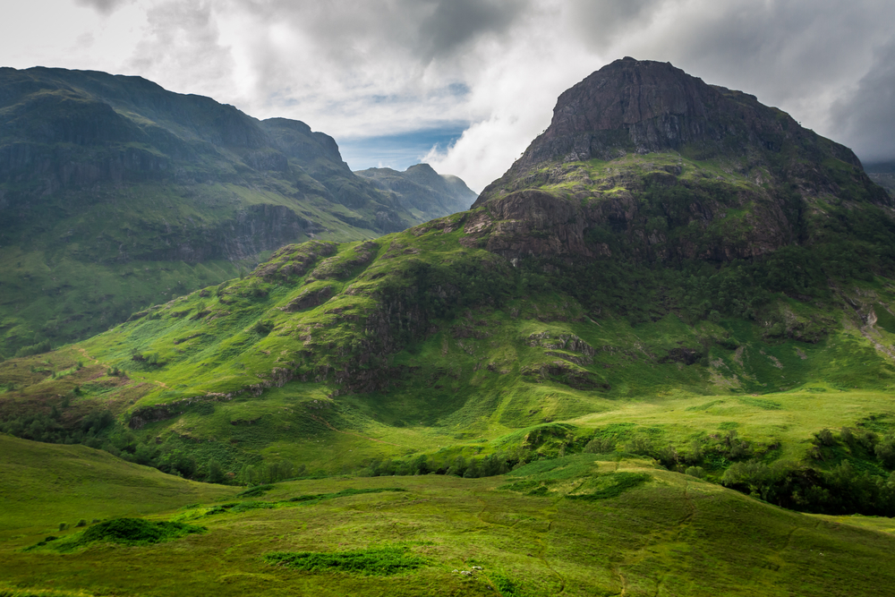 Summer in in the Scotland highlands, with mountains and hill as far as the eye can see.
