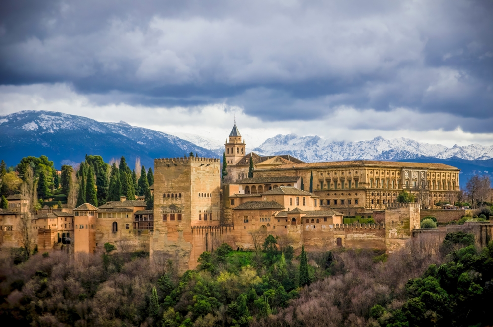 Granada's hilltop palace fortress fuses Islamic artistry with Renaissance flair is a fairytale place to visit in Europe is Alhambra in Spain