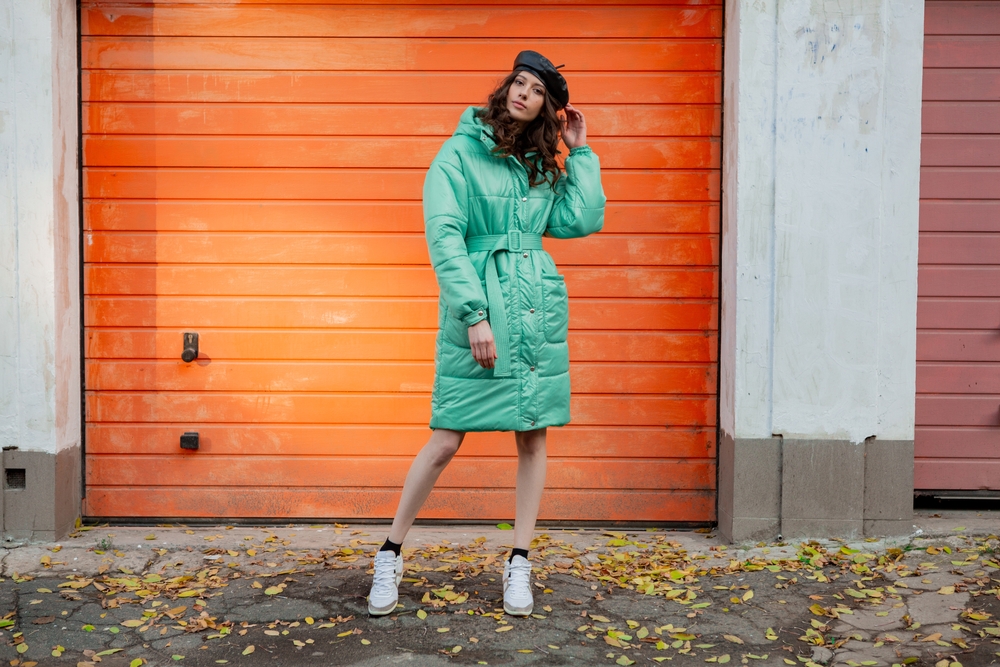 When wondering What to wear to Paris in November, consider a giant puffy coat, as seen on this girl in green, to keep warm!