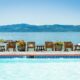 swimming pool overlooking the lake with mountains in the background. This article is about best all-inclusive resorts for families in the USA