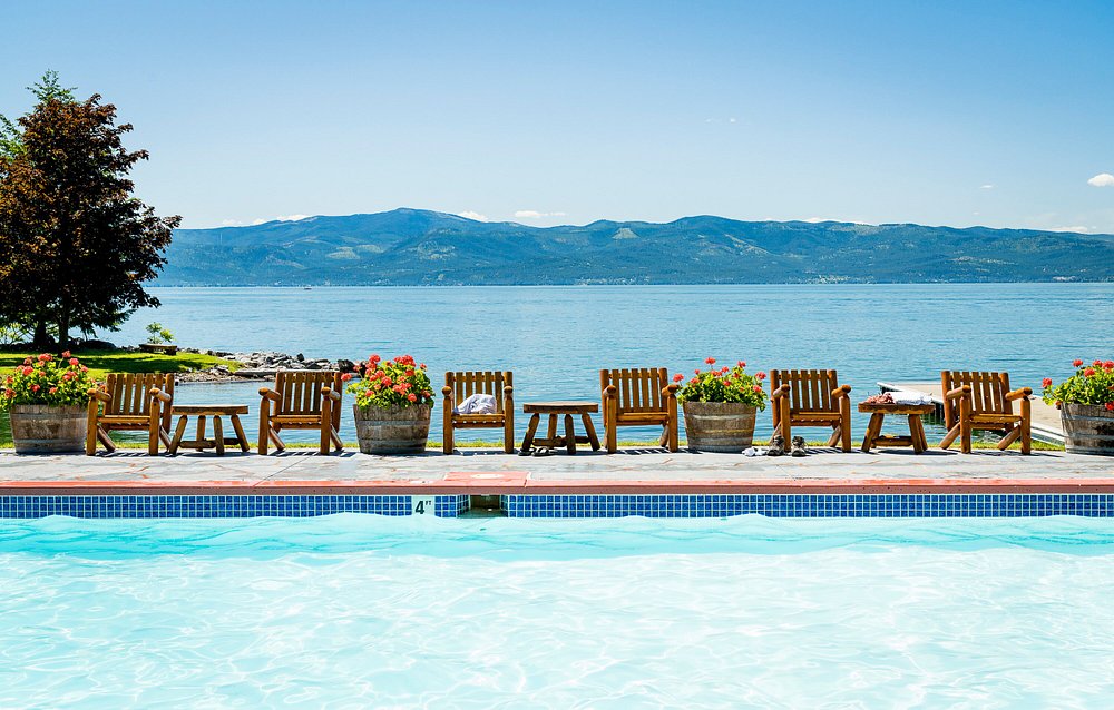 swimming pool overlooking the lake with mountains in the background. This article is about best all-inclusive resorts for families in the USA