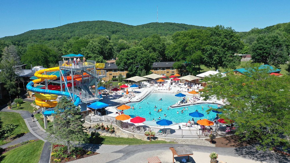 Waterpark in a hotel it is outdoor surrounded by trees.