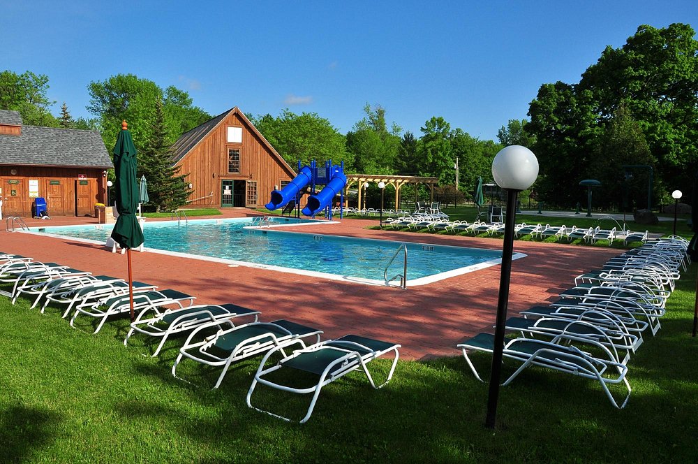 swimming pool with children's slides. There are loungers around the pool.