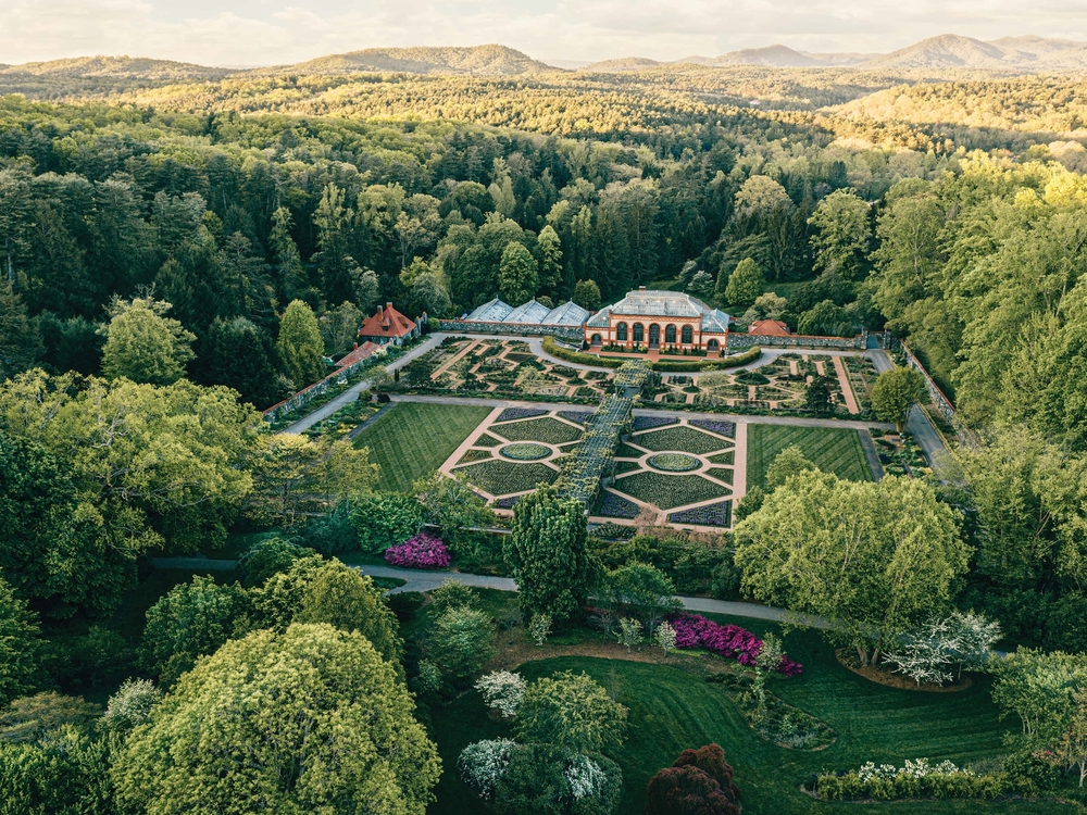an aired view of the Biltmore Fairytale castle in Asheville with gardens