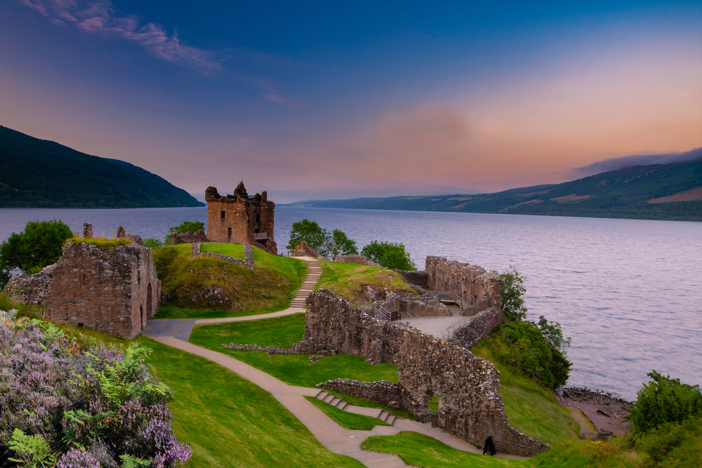 Urquhart Castle at sunset located on the banks of Loch ness, Scotland. The article is about Buy From Amazon Before Scotland.