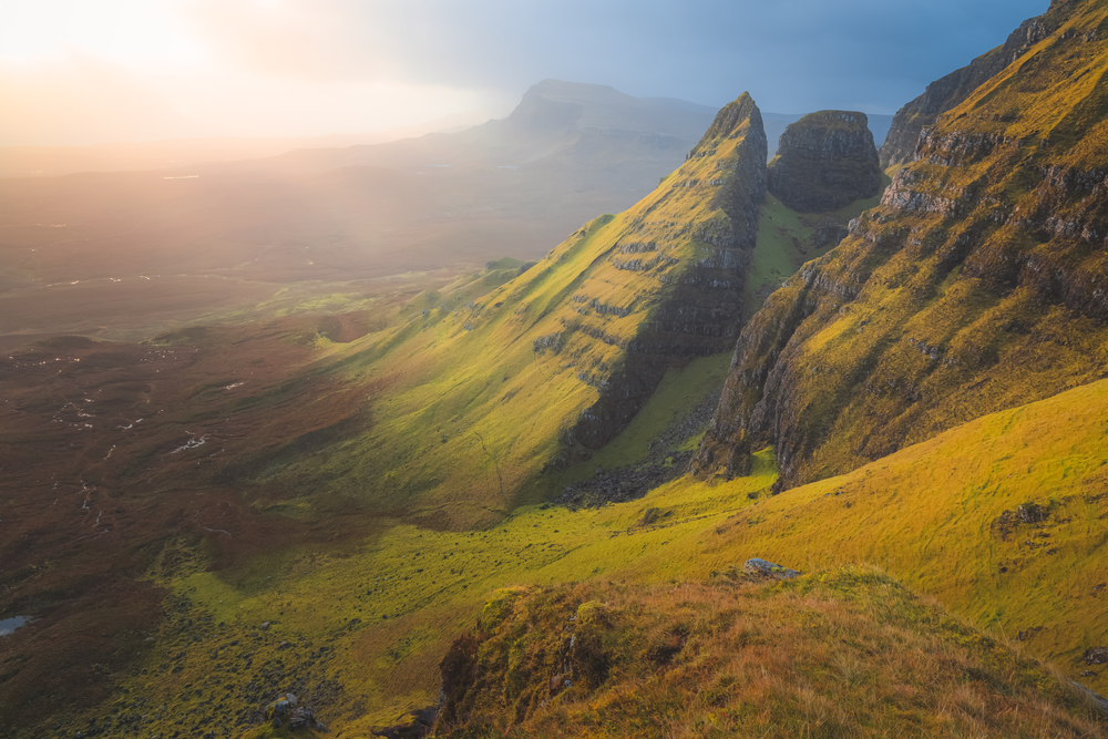 Golden ethereal sunrise or sunset light over beautiful, idyllic mountain landscape of Dun Dubh at the Quiraing on the Isle of Skye, Scottish Highlands, Scotland.