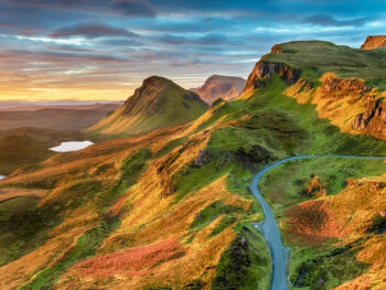 Beautiful sunrise sky over rock formations on the Quiraing, an ancient landslip on the eastern face of Meall na Suiramach on the Ilse of Skye in Scotland. The article is about Buy From Amazon Before Scotland.