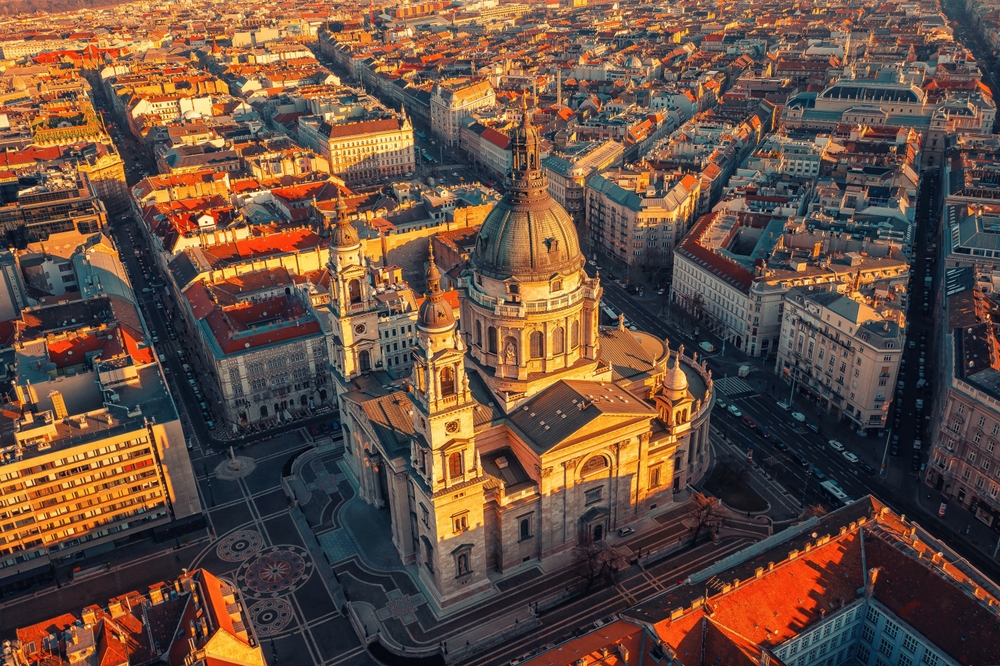 arial photo of budapest, a large building in the. middle and smaller homes around it