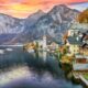 Mountains tower in the sunset of this European town, and the turn of leaves match the autumn hues of the homes on the lack: you can see things like this too if you prepare and know what things to buy from Amazon for Europe.