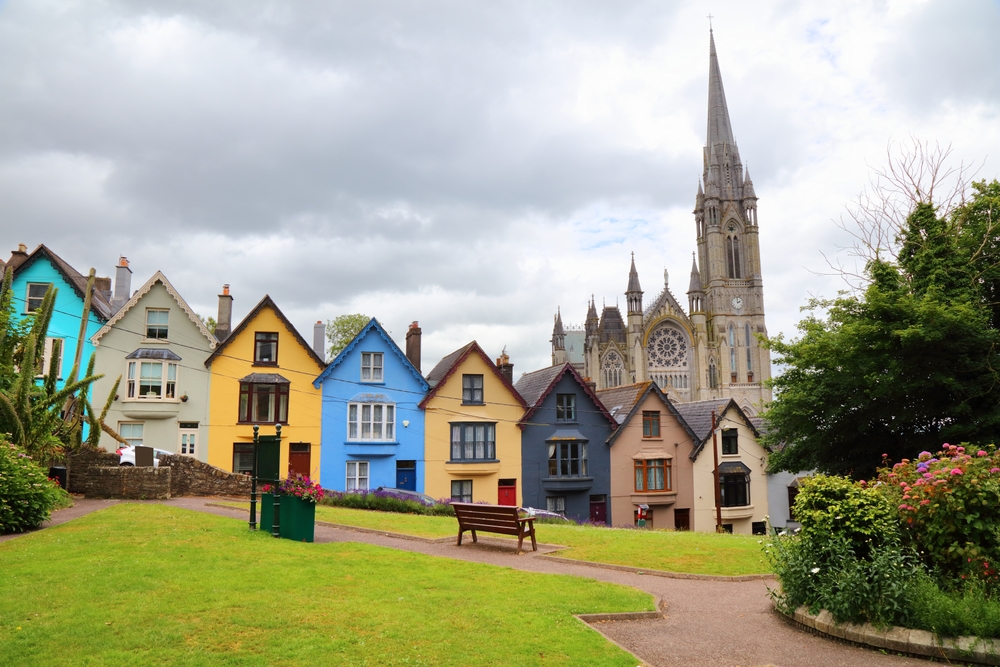 In Cork, brightly colored houses touching each other cascade down a hill and a church is in the background standing tall: you can see this too when you know things to buy from Amazon for Ireland.