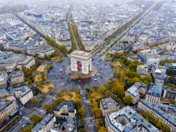 An overhead shot shows the famous roundabout and arc in Paris as cars circle around it: knowing how to navigate things like this can come from a guide book, which is one of the many things to buy from Amazon for Paris.