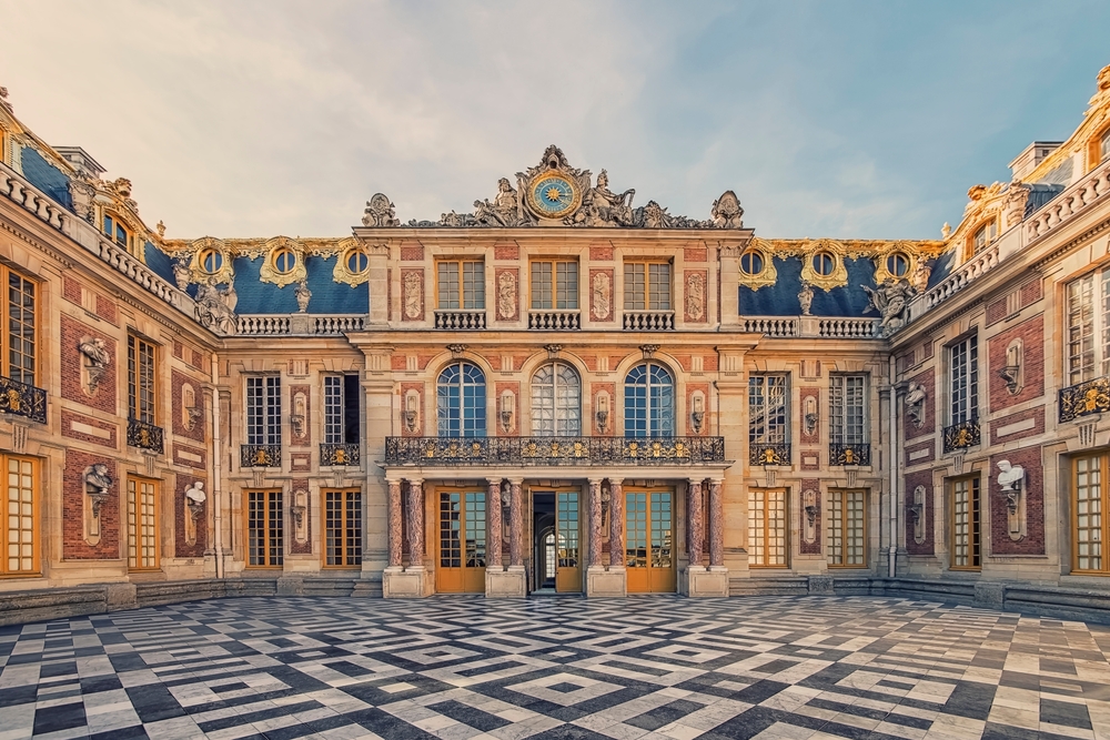 Versailles is stunning with its marble floors, golden windows, busts, and wide doors.
