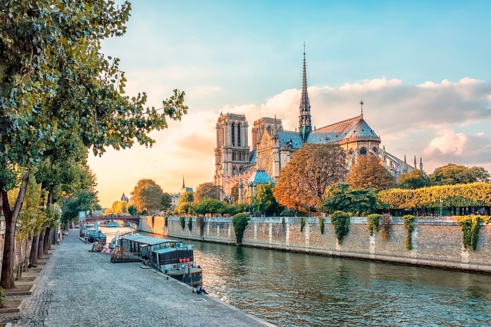Notre Dame, after the fire, shows a towering glass steeple in the middle that glows during golden hour, and boats and greens around the building glisten: you can see things like this if you know what things to buy from Amazon for Paris.