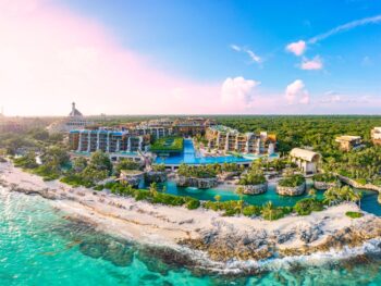 An overhead shot shows an all-inclusive resort with blue pools, towering rooms, private pools and more: staying here is only one part of vacation, the other is to know which things to buy from Amazon for an all-inclusive resort.