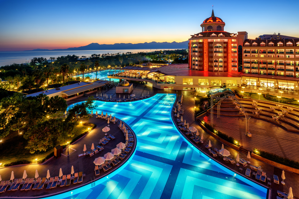 At night, the all-inclusive resort is a aglow with lights, the blue pool and warm hues echoing in the sunset.