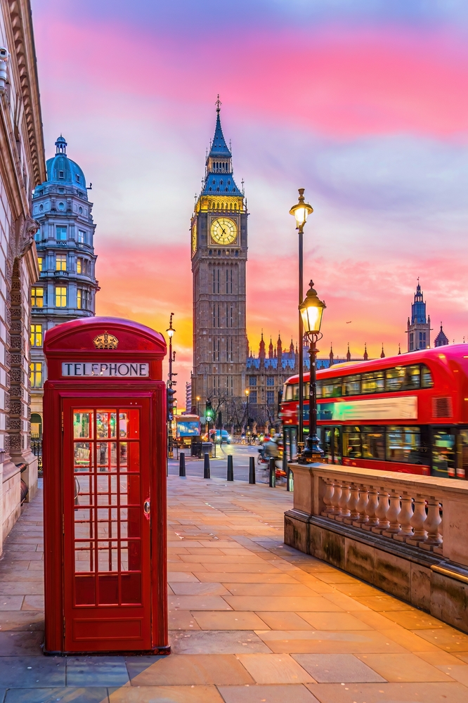 Big Ben tower of Houses of Parliament with telephone booth, Westminster in London, UK at sunrise. This article is about Things To Buy From Amazon Before Visiting London. 
