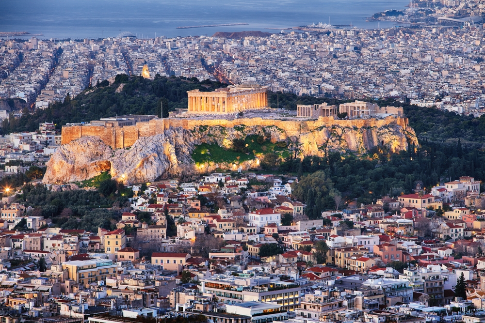 Aerial view over Athens with te Acropolis and harbour from Lycabettus hill, Greece at sunrise