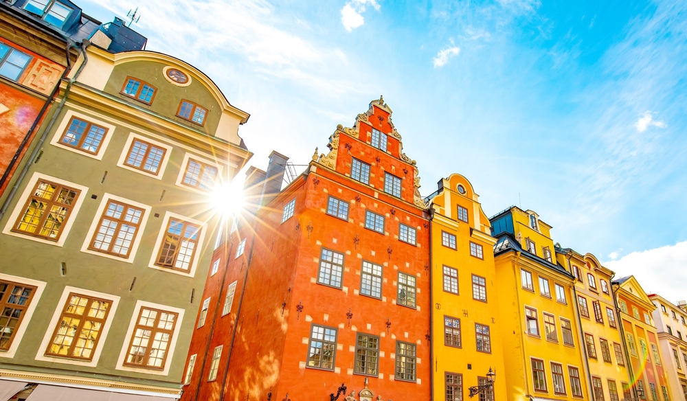Sun peeps through the cracks of brightly colored houses on one's vacation, and this was all possible because of the things to buy from amazon for vacation.