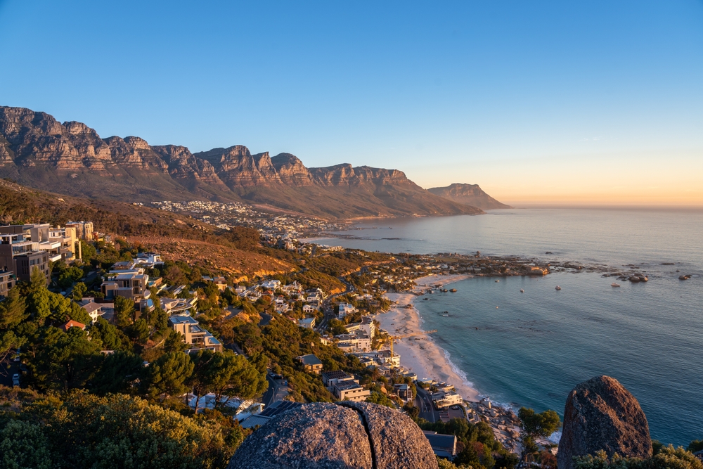 Cape Town Africa is full of stunning mountains and sloping hills that look over coasts of sand and blue waters, residences scattered throughout.