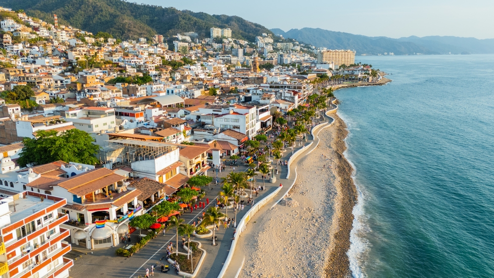 An overhead shot of Puerto vallarta shows the edge of civilization coming to a hault on the coast, where warm sand meets blue waters, so when you're staying here you are close by and you know that this is one of the Best Places to Celebrate Christmas on The Beach.