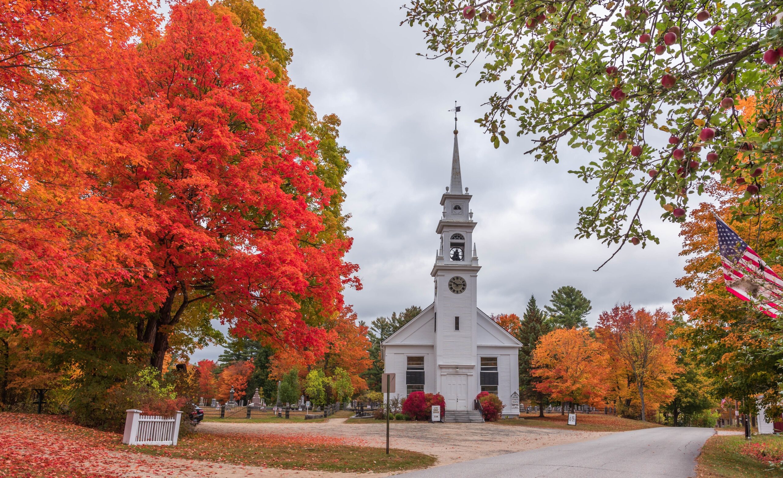 A beautiful shot of the Sandwich new Hampshire church surrounded by autumn trees