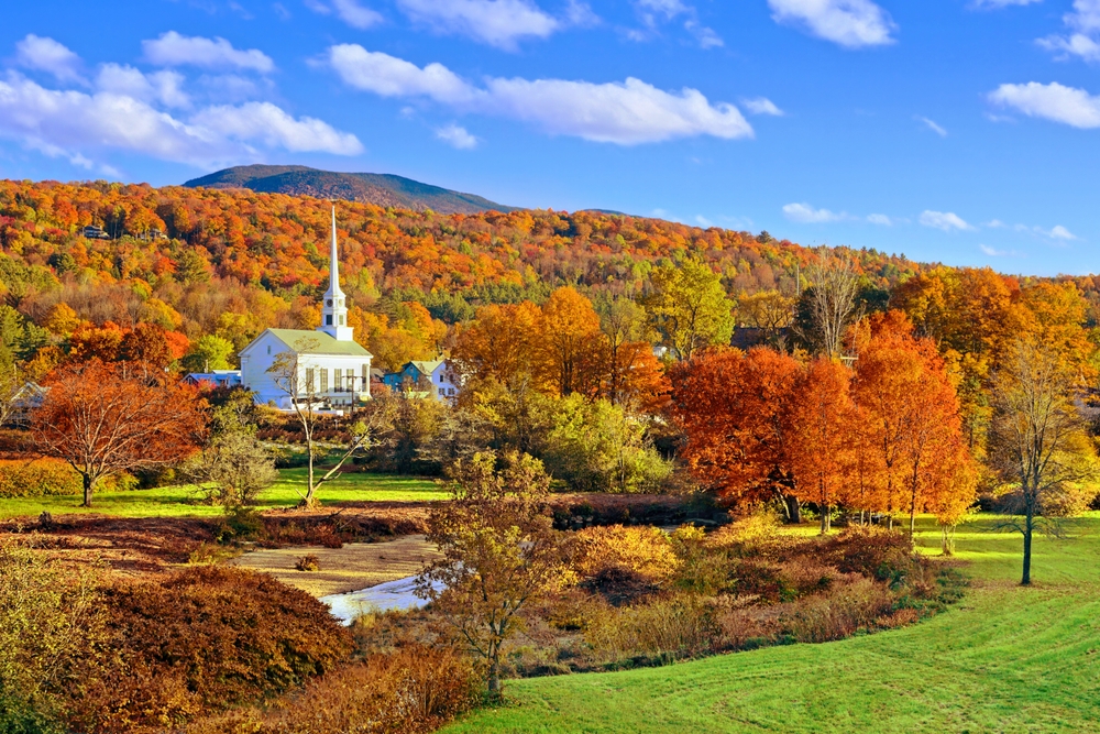 Autumn countryside view of the town of Stowe with white church and fall colors, Vermont.