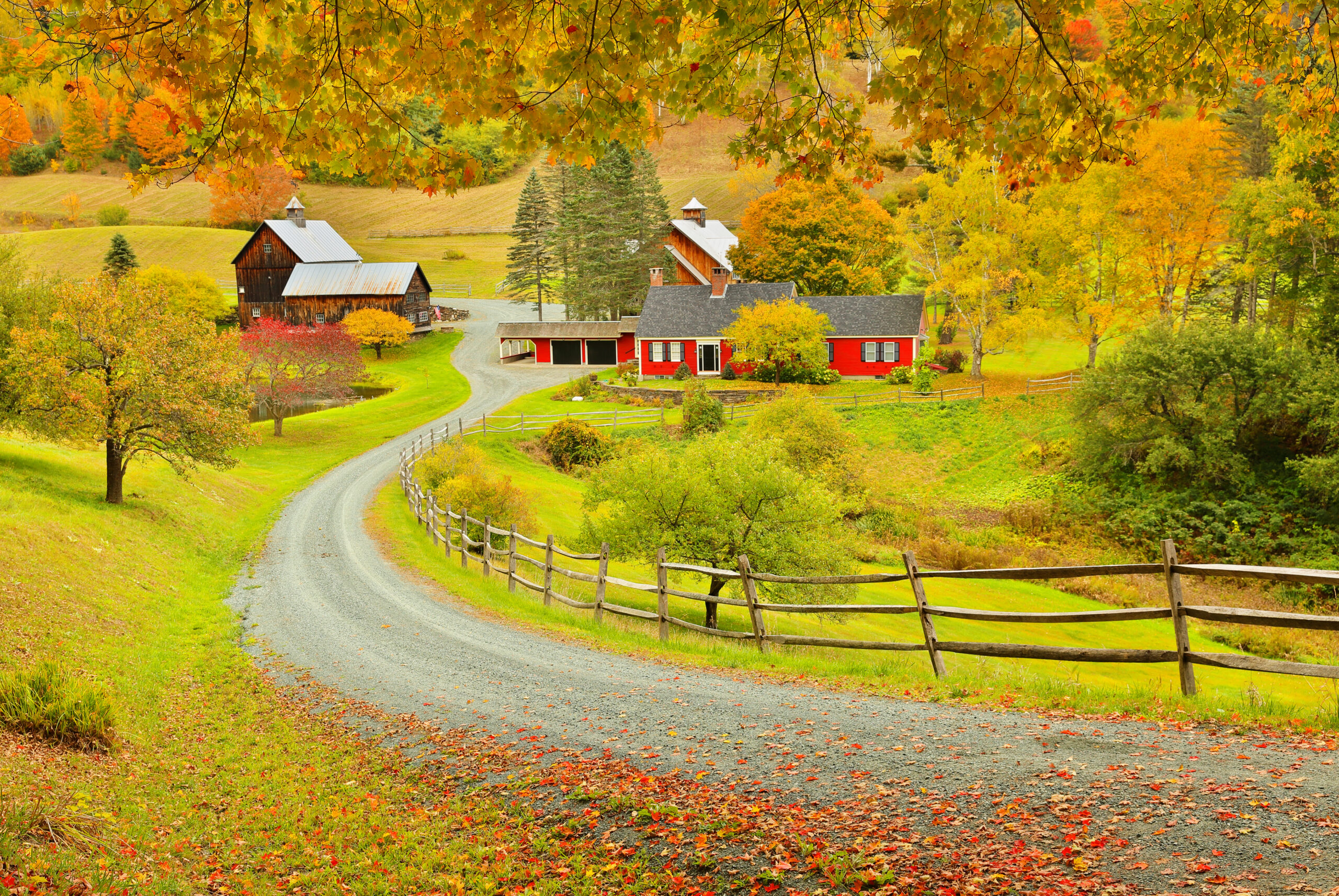 Overlooking a peaceful New England Farm in the autumn, Woodstock, Vermont. The article is about towns in New England that feel like a hallmark movie.