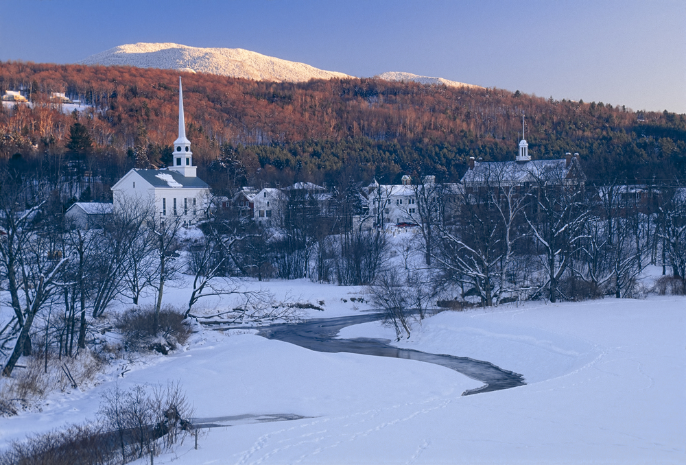 A nature shot in Stowe shows snow covering a church, ground, freezing a lake and more.