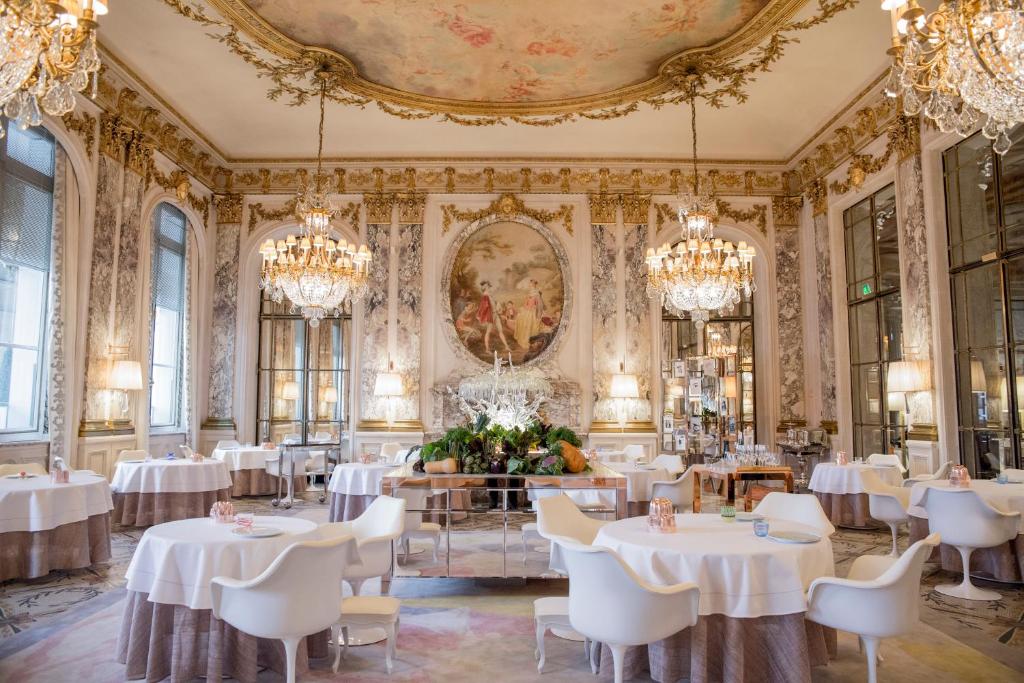 This hotel in Paris is one of the 10 Most Luxurious Hotels to Spend Christmas Around the World, as you can tell with their ornate dining room with white linen, gold lining and more.