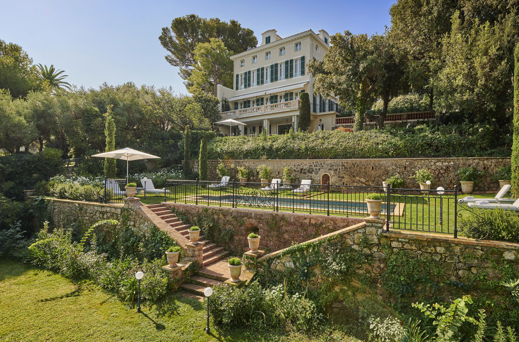 This photo of Hotel du Cap-Eden-Roc in the French Riviera shows a private villa overlooking a pool with tons of greenery.