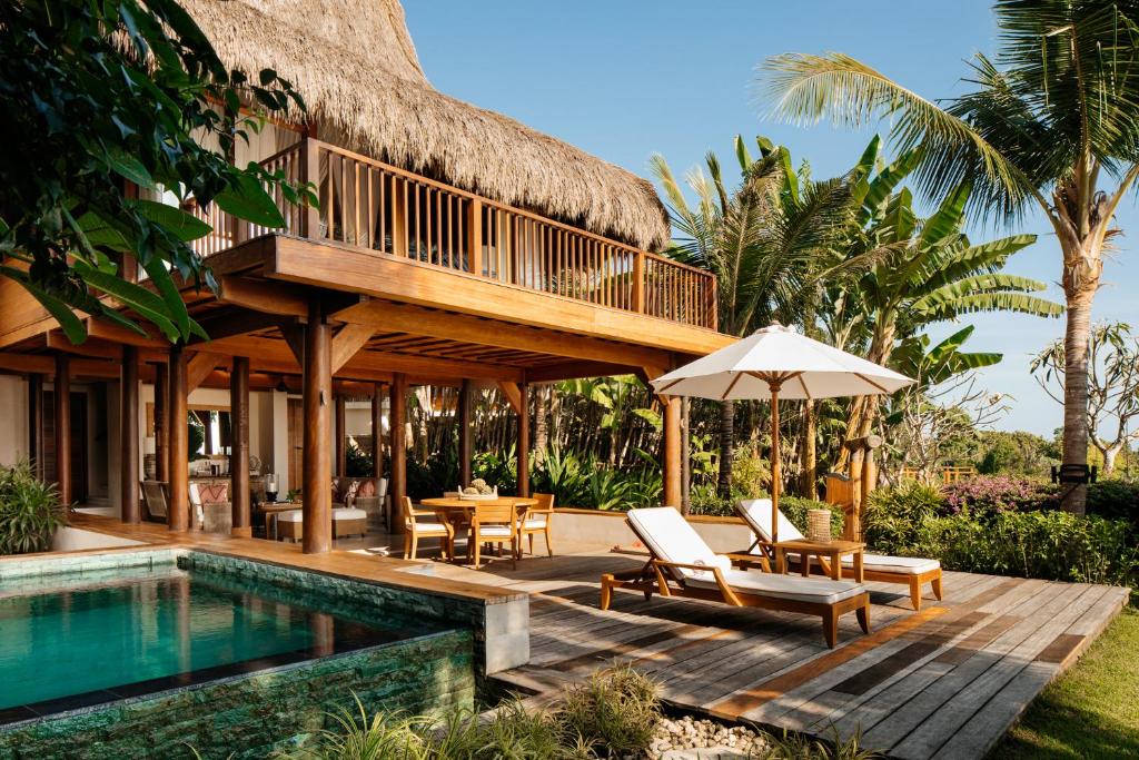 The NIHI Sumba in Indonesia, which is one of the 10 Most Luxurious Hotels to Spend Christmas Around the World, features a tropical vibe with lounge chairs by private balconies and pools.