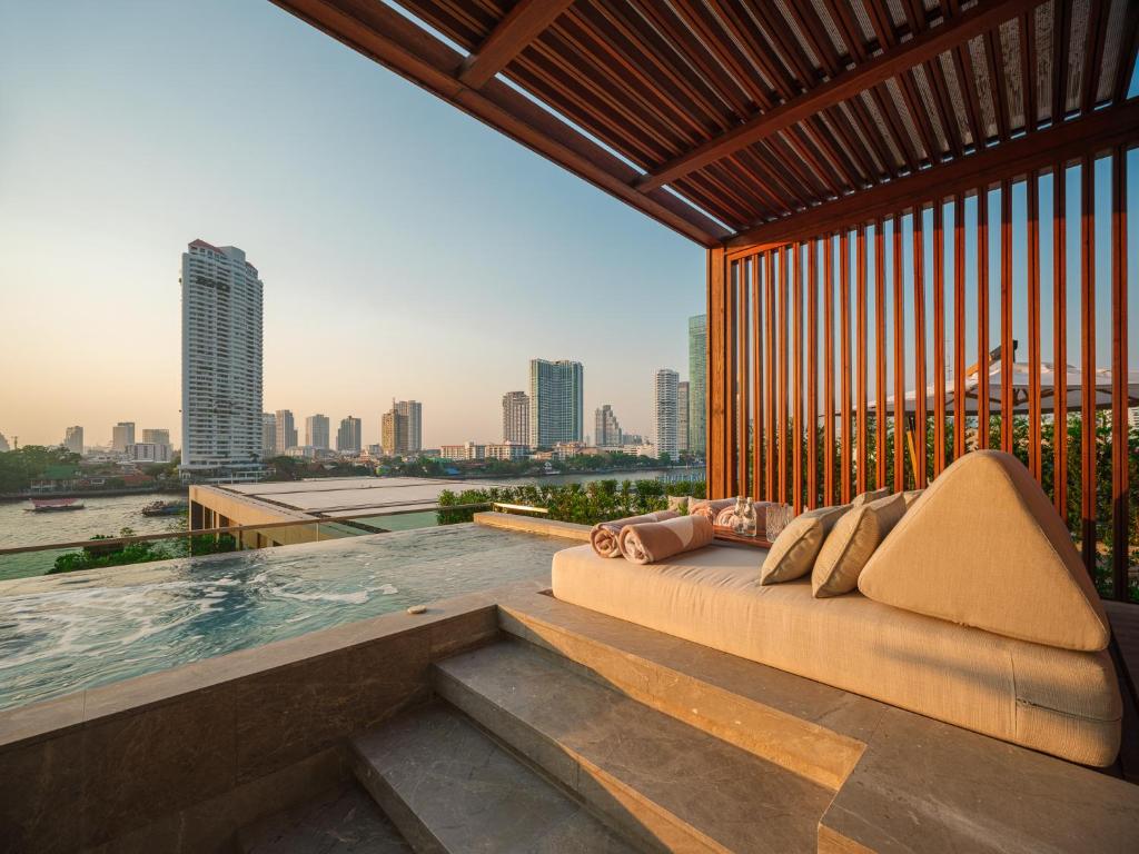 In Thailand, the Capella Bangkok features an infinity pool that overlooks a city with luxury couches and more.
