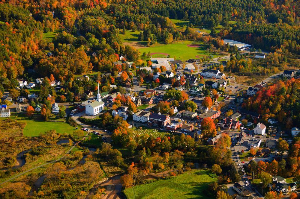 An overhead shot of vermont shows Stowe, a town that features tons of roads and quaint experiences during fall.
