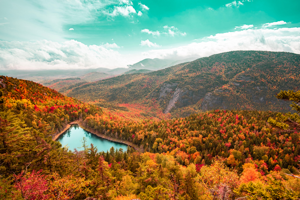 An overhead shot of Adriondack Mountains shows the trees turning vibrant colors, lakes galore and more.