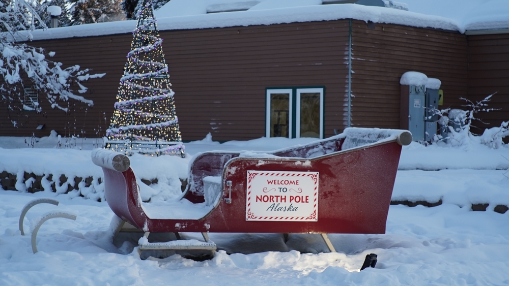 a sled and Christmas tree at the North Pole in Alaska Best christmas vacations in the USA for a magical feeling