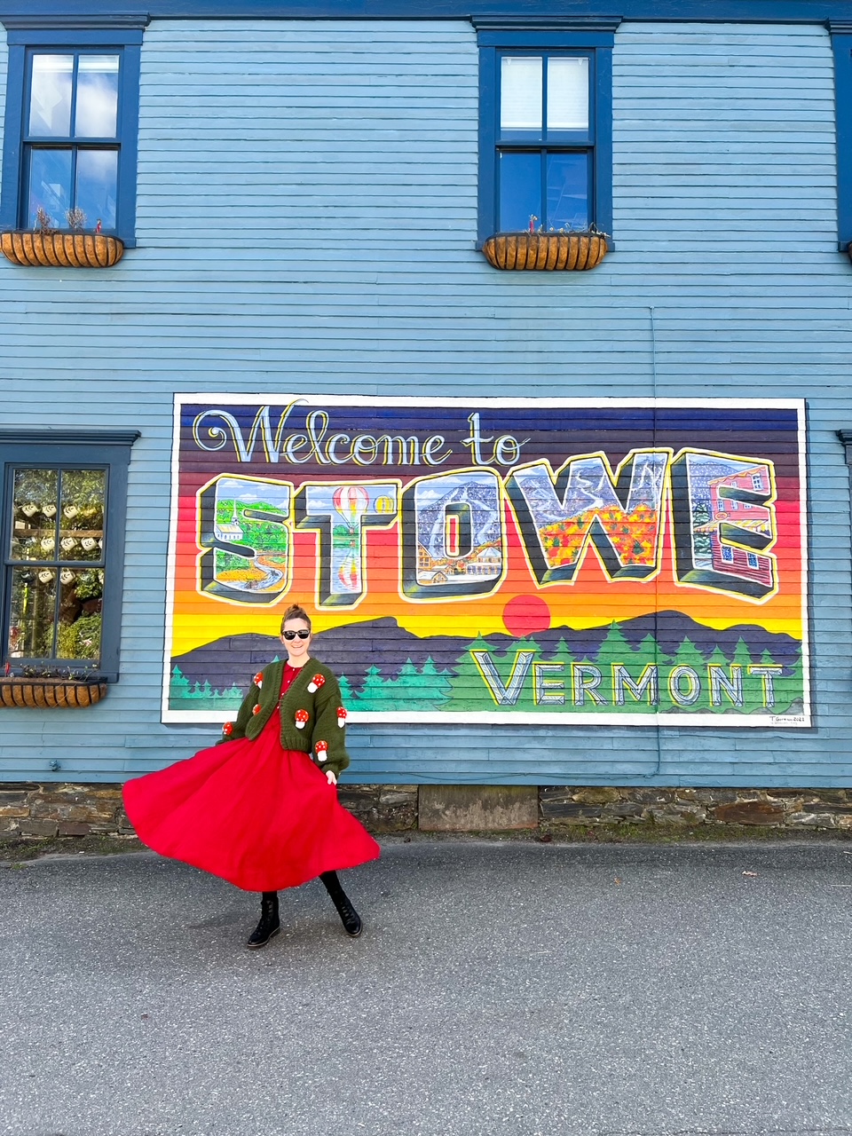 a girl in a red dress in front of the STOWE sign in this charmign fall town