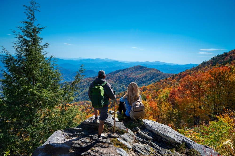 a couple on top of the mountain enjoying beautiful autumn scenery. Blue Ridge Mountains, near Asheville, one fo the most romantic small towns in the US