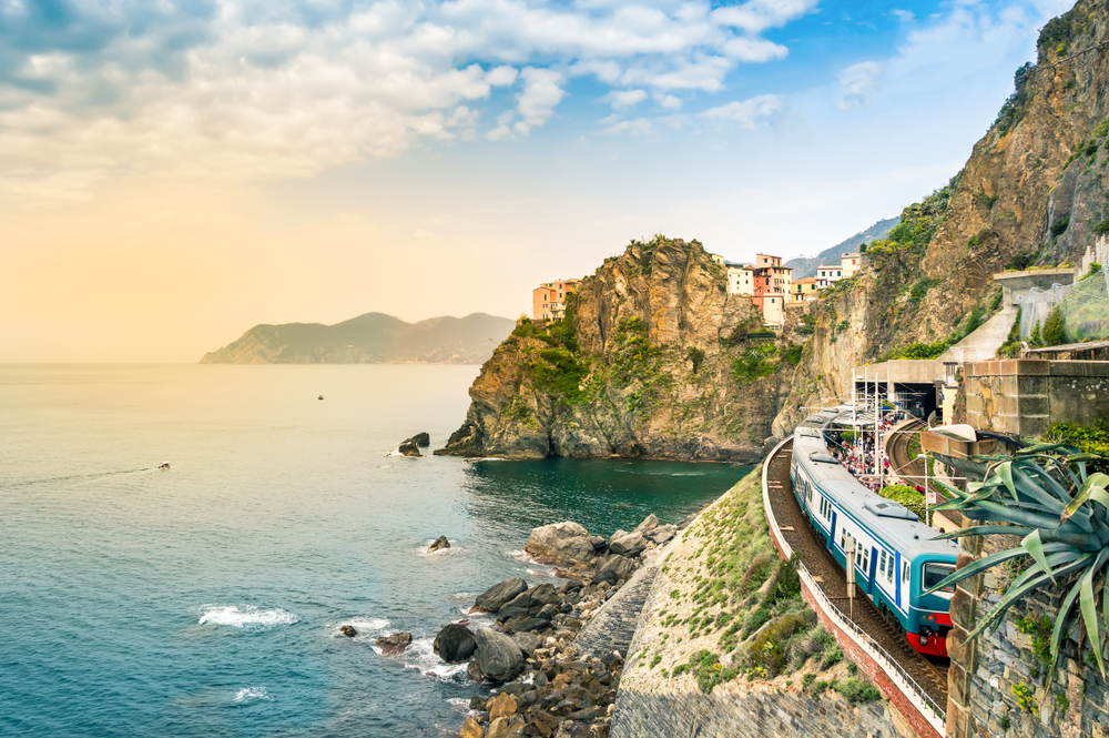 Manarola, Cinque Terre - train station in small village with colorful houses on cliff overlooking sea. Cinque Terre National Park